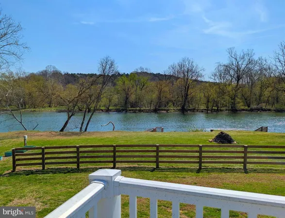 a view of a lake with houses in the back