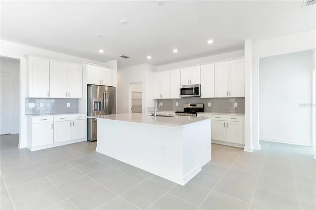 a kitchen with a sink stove and refrigerator
