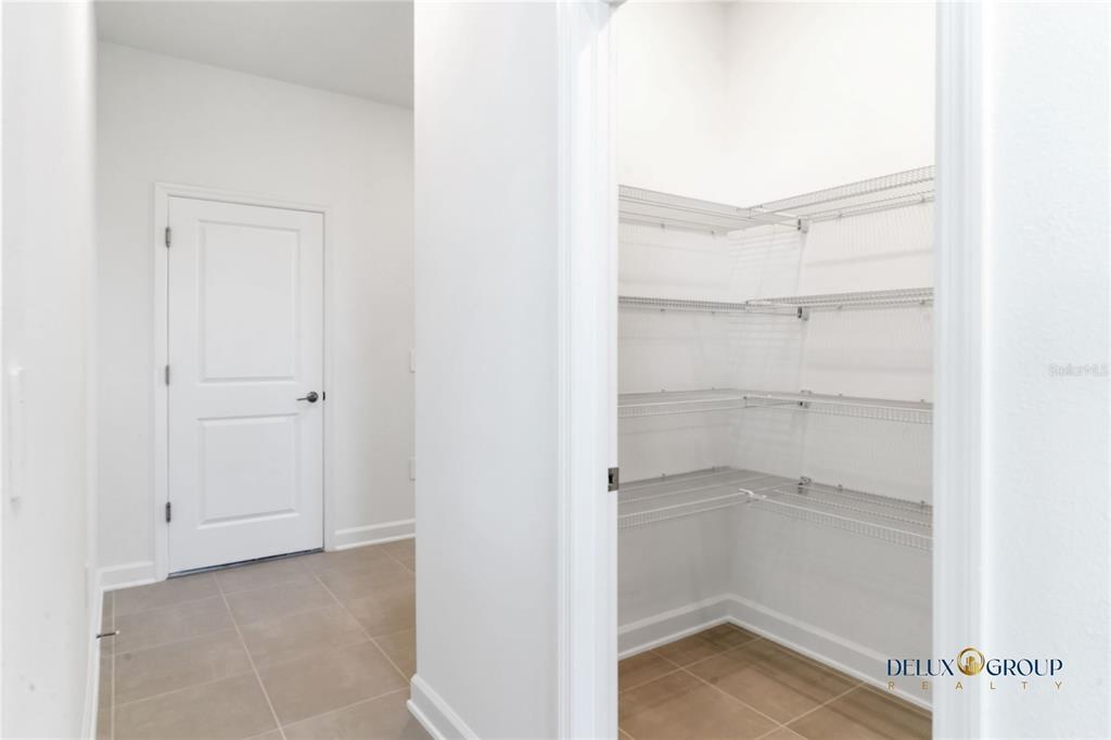 2947 Believe In Yourself Court Clermont, FL 34714 - Photo 17 of 50 a view of an empty walk in closet with empty racks