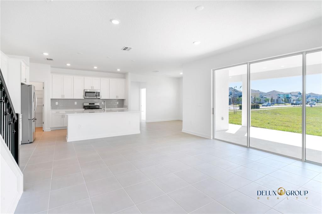 2947 Believe In Yourself Court Clermont, FL 34714 - Photo 22 of 50 a view of kitchen with stainless steel appliances kitchen island large window and wooden floor