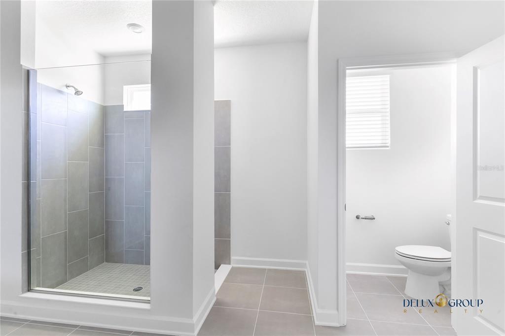 2947 Believe In Yourself Court Clermont, FL 34714 - Photo 28 of 50 a bathroom with a toilet and a shower