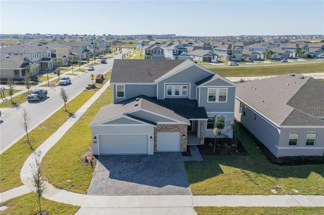 an aerial view of a house with a swimming pool