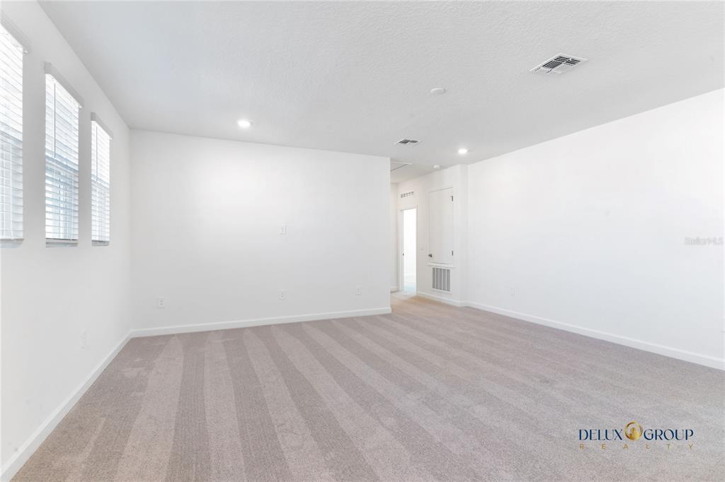 2947 Believe In Yourself Court Clermont, FL 34714 - Photo 33 of 50 a view of an empty room with wooden floor and a window