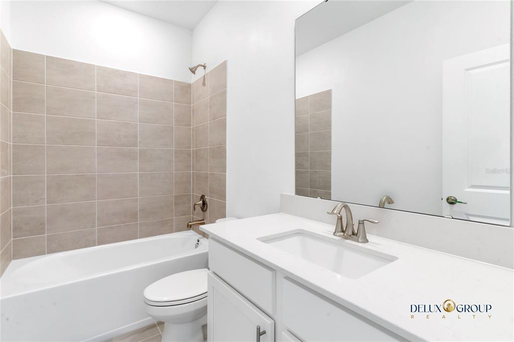 2947 Believe In Yourself Court Clermont, FL 34714 - Photo 45 of 50 a bathroom with a sink a toilet and shower