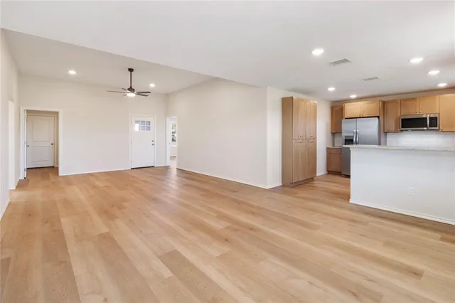 a view of a kitchen with a sink and a refrigerator