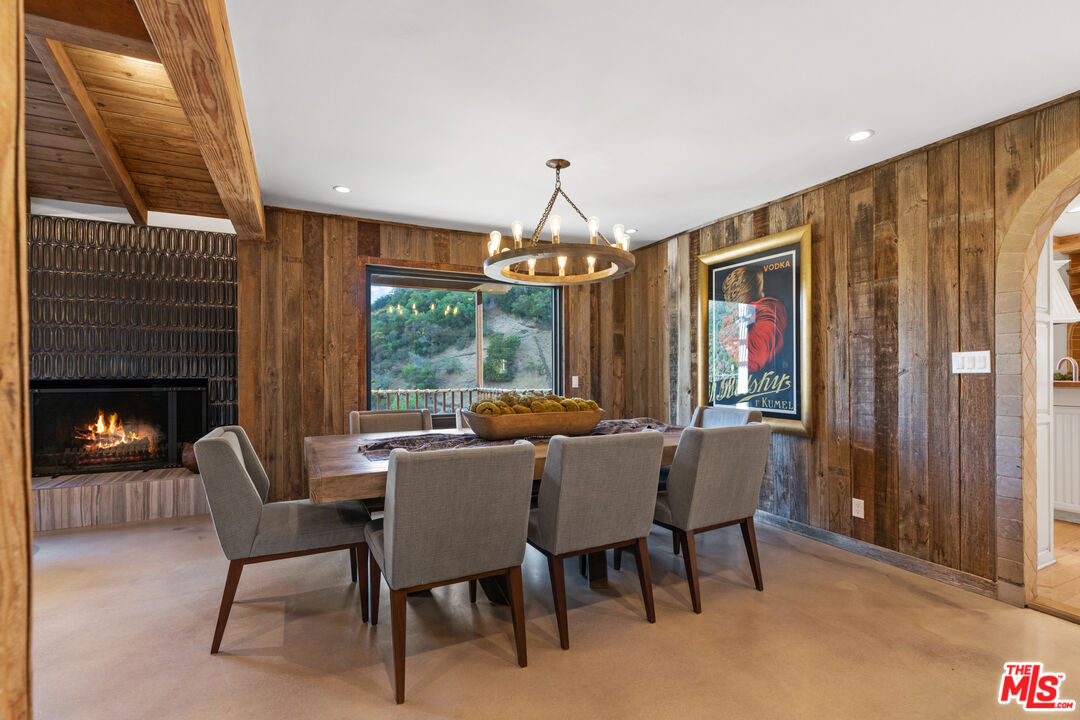 3371 Mandeville Canyon Road Los Angeles, CA 90049 - Photo 12 of 44 a view of a dining room with furniture window and outside view