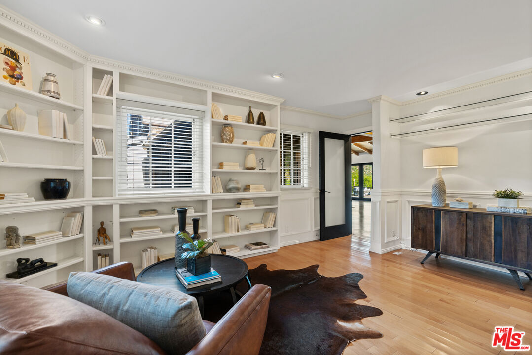 3371 Mandeville Canyon Road Los Angeles, CA 90049 - Photo 19 of 44 a living room with furniture and wooden floor