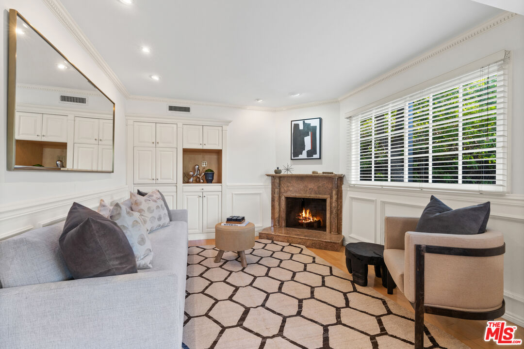 3371 Mandeville Canyon Road Los Angeles, CA 90049 - Photo 20 of 44 a living room with furniture and a fireplace