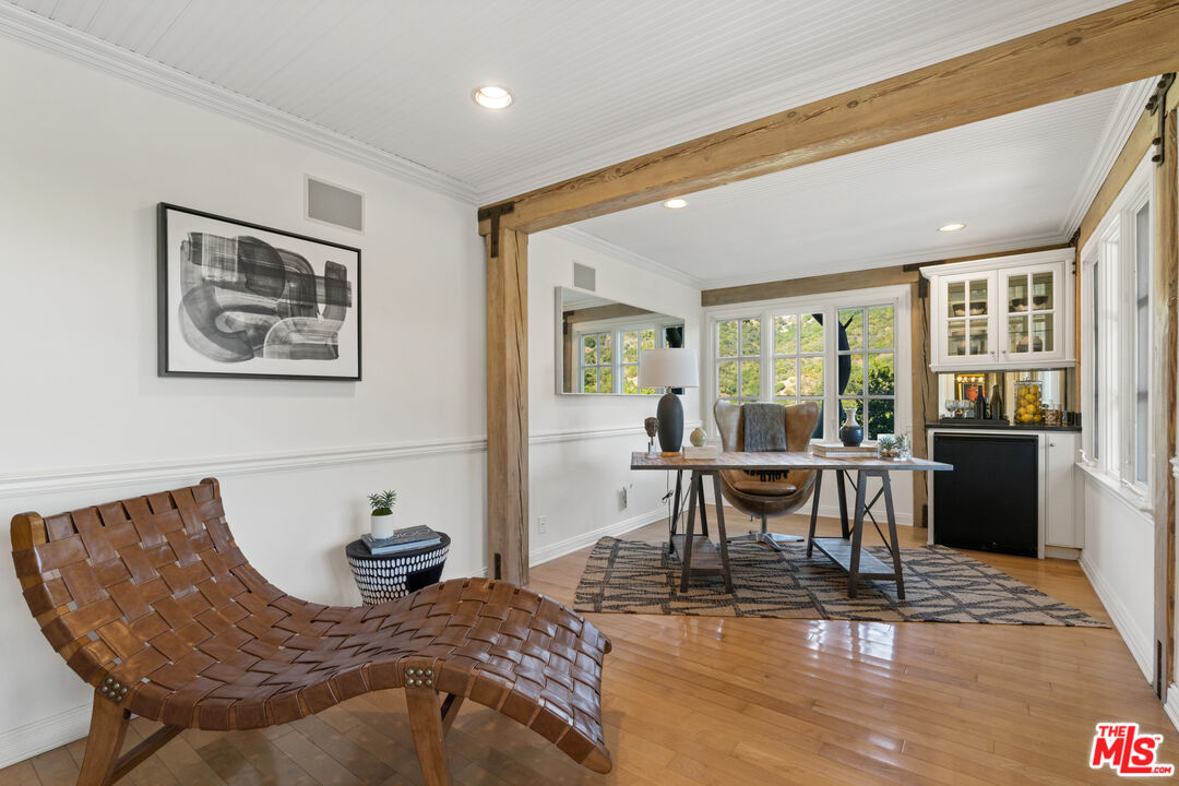 3371 Mandeville Canyon Road Los Angeles, CA 90049 - Photo 22 of 44 a view of a dining room with furniture window and wooden floor