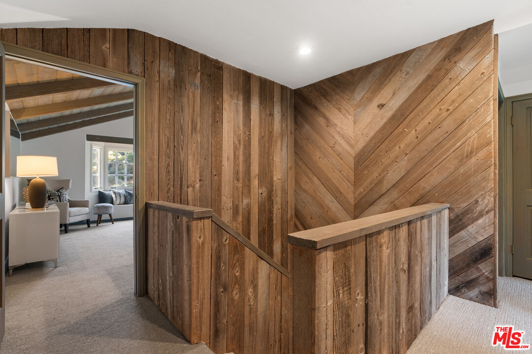 3371 Mandeville Canyon Road Los Angeles, CA 90049 - Photo 23 of 44 a view of a hallway to a livingroom with furniture