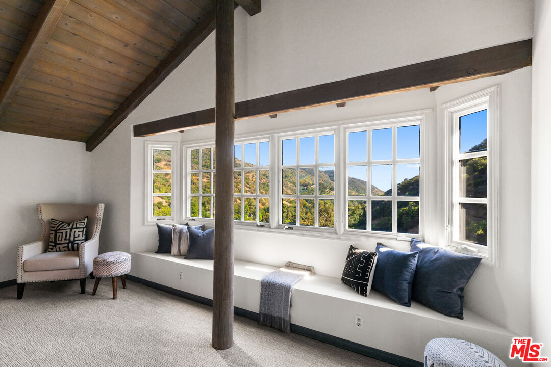 3371 Mandeville Canyon Road Los Angeles, CA 90049 - Photo 26 of 44 a living room with furniture and a large window