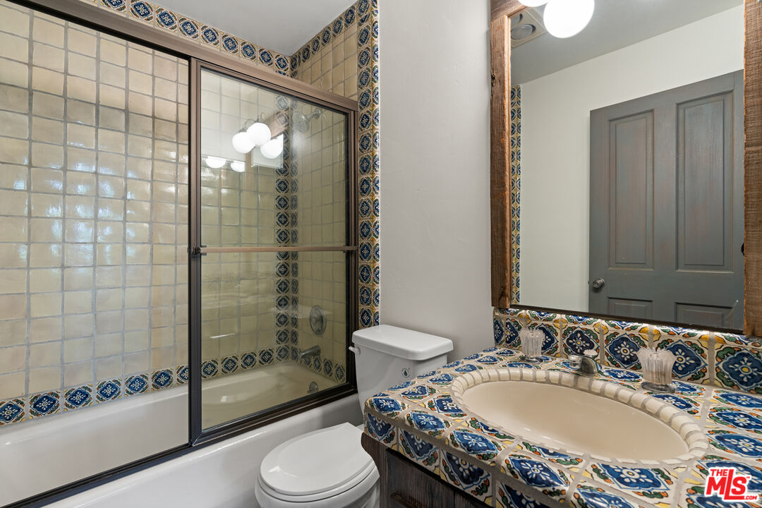 3371 Mandeville Canyon Road Los Angeles, CA 90049 - Photo 29 of 44 a bathroom with a sink and a toilet