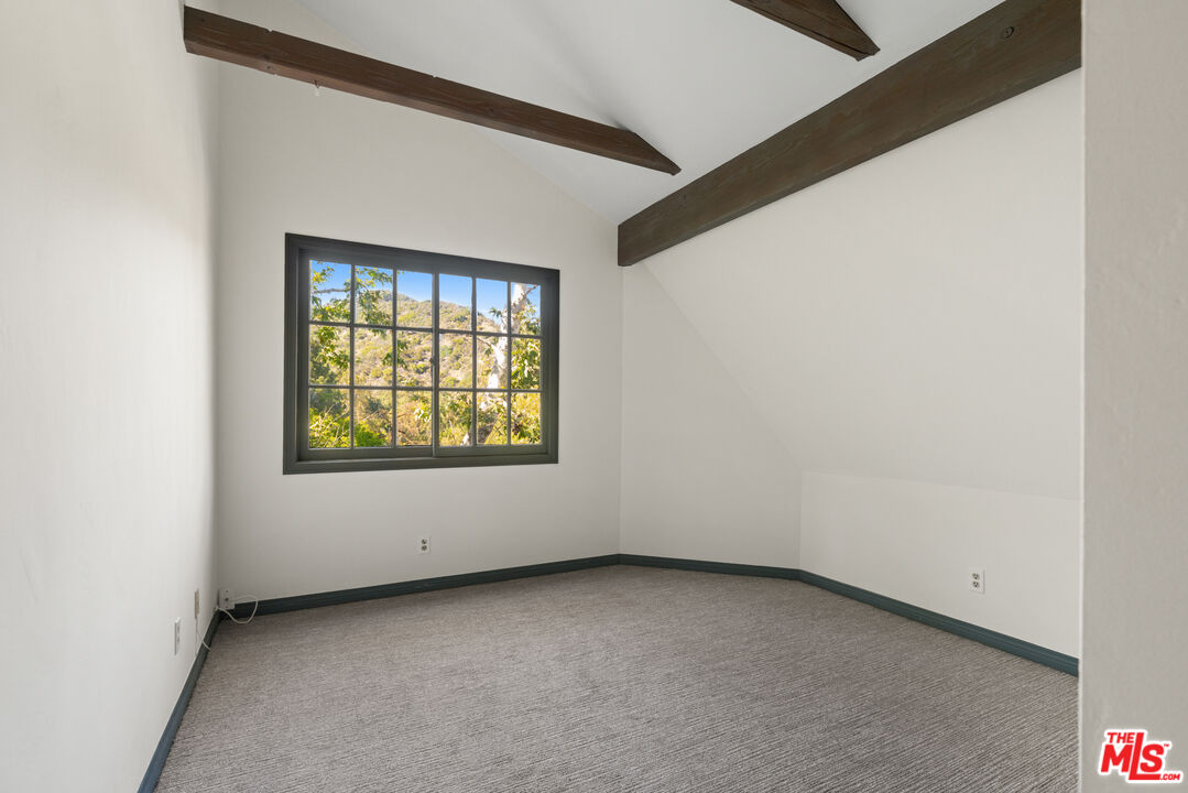 3371 Mandeville Canyon Road Los Angeles, CA 90049 - Photo 30 of 44 a view of an empty room with a window