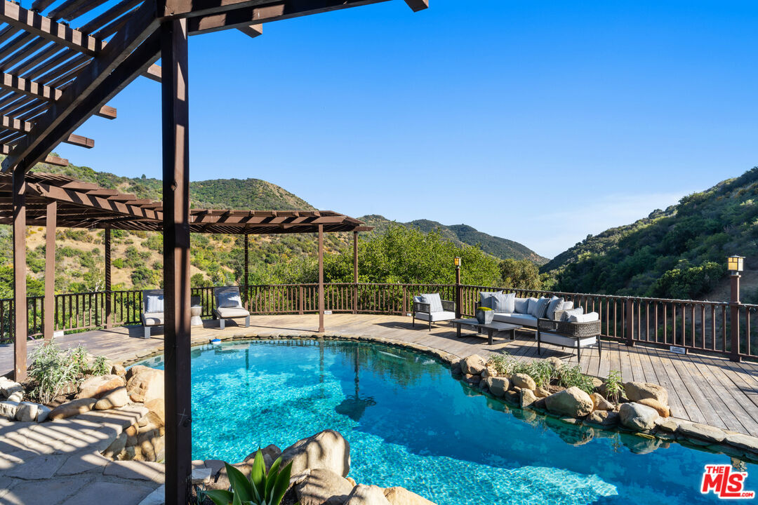 3371 Mandeville Canyon Road Los Angeles, CA 90049 - Photo 38 of 44 a view of swimming pool with a patio