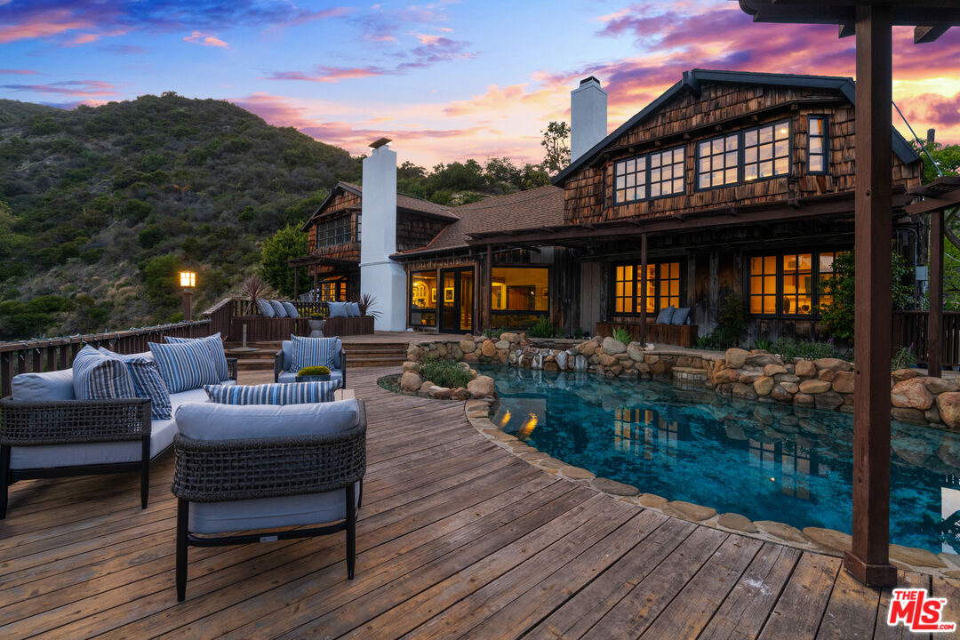 3371 Mandeville Canyon Road Los Angeles, CA 90049 - Photo 40 of 44 a view of a roof deck with couches