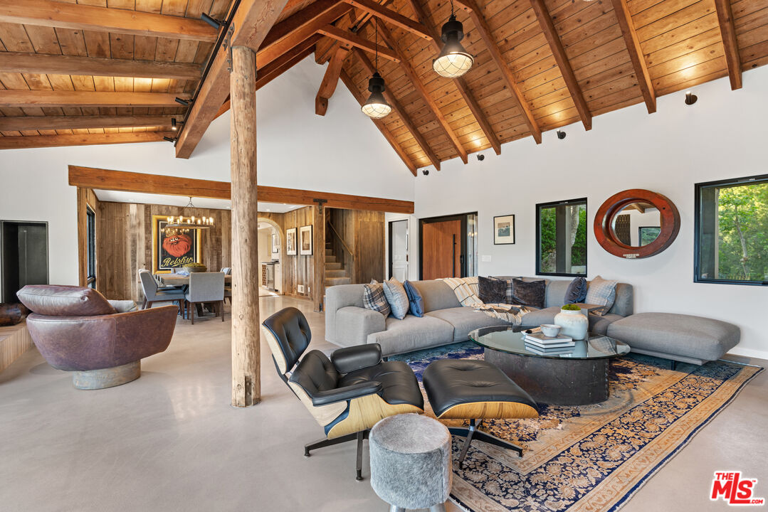 3371 Mandeville Canyon Road Los Angeles, CA 90049 - Photo 9 of 44 a living room with furniture and a clock