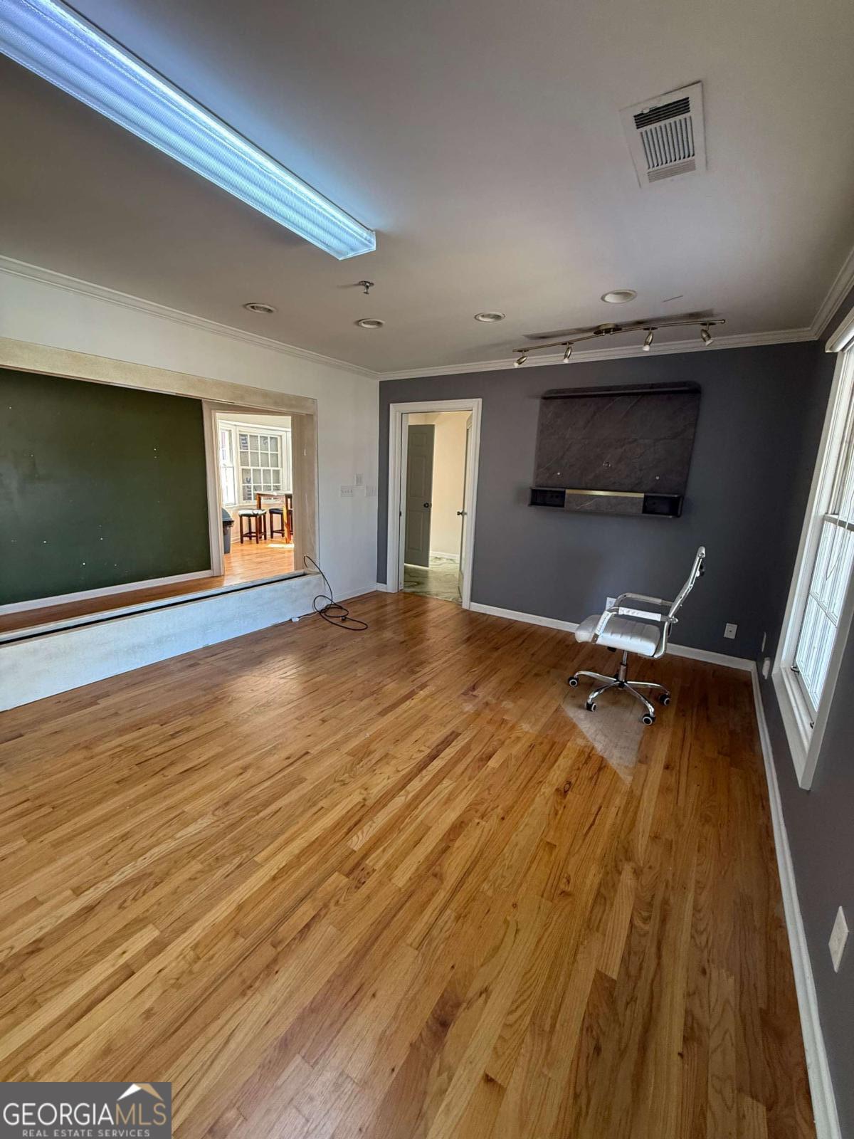 1001 Oak Road Southwest, Unit 1 Lilburn, GA 30047 - Photo 3 of 12 a view of an empty room with wooden floor and a window