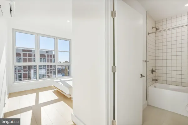 a bathroom with a bathtub and a shower