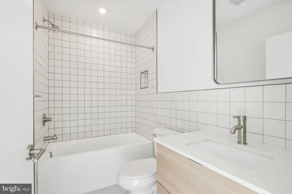 a bathroom with a bathtub and sink