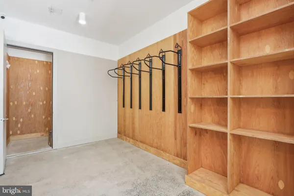 a view of walk in closet with empty racks