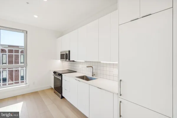 a kitchen that has a sink and a stove in it