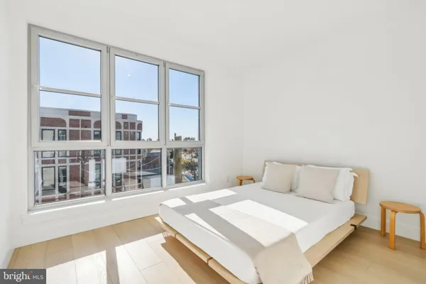 a bedroom with a large bed and a large window