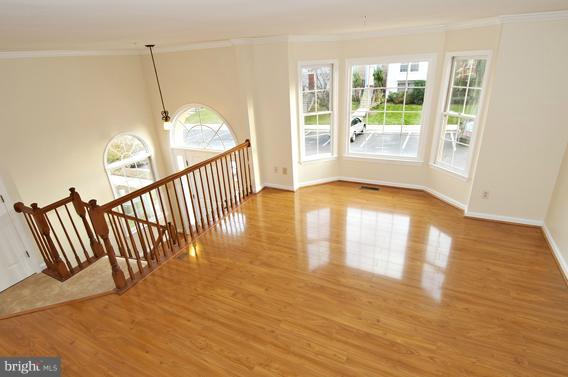 2247 Conquest Way, Unit 63 Odenton, MD 21113 - Photo 2 of 30 a view of an empty room with wooden floor and a window
