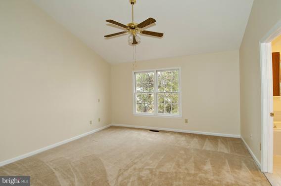 2247 Conquest Way, Unit 63 Odenton, MD 21113 - Photo 18 of 30 an empty room with a ceiling fan and window