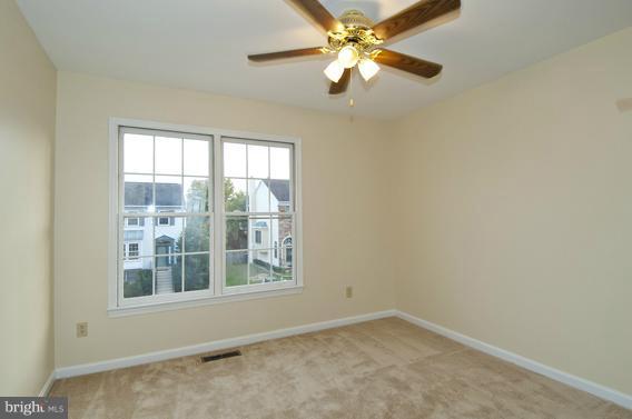 2247 Conquest Way, Unit 63 Odenton, MD 21113 - Photo 21 of 30 an empty room with a window and a fan