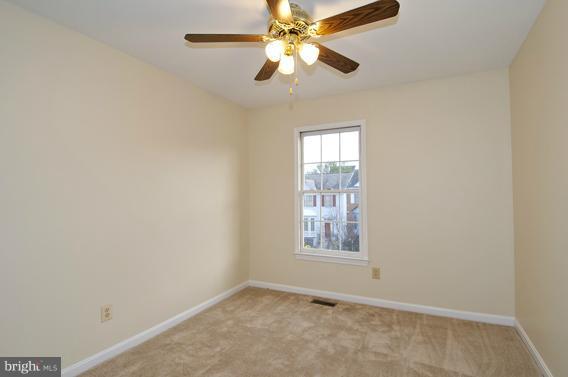 2247 Conquest Way, Unit 63 Odenton, MD 21113 - Photo 22 of 30 an empty room with windows and fan
