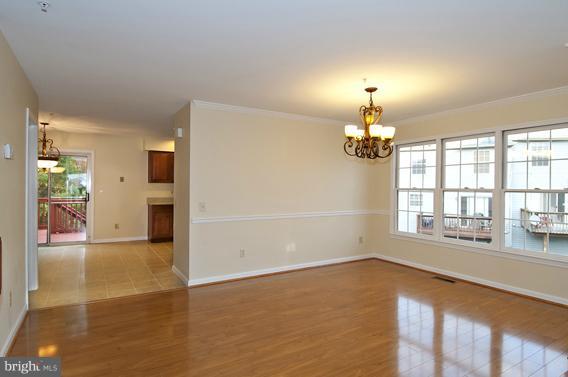 2247 Conquest Way, Unit 63 Odenton, MD 21113 - Photo 7 of 30 an empty room with chandelier and windows