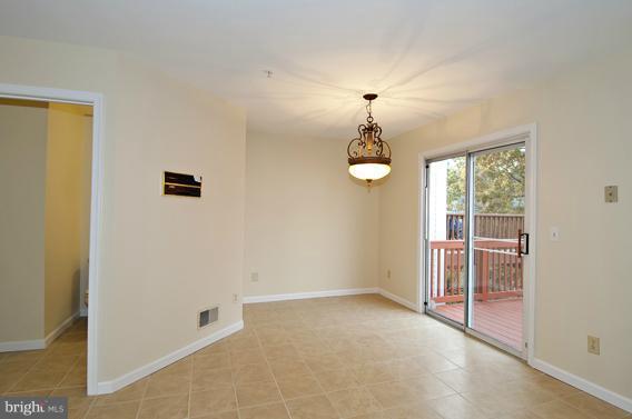 2247 Conquest Way, Unit 63 Odenton, MD 21113 - Photo 8 of 30 an empty room with windows and chandelier fan