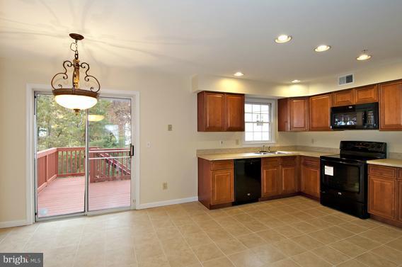 2247 Conquest Way, Unit 63 Odenton, MD 21113 - Photo 9 of 30 a large kitchen with granite countertop a stove and a sink