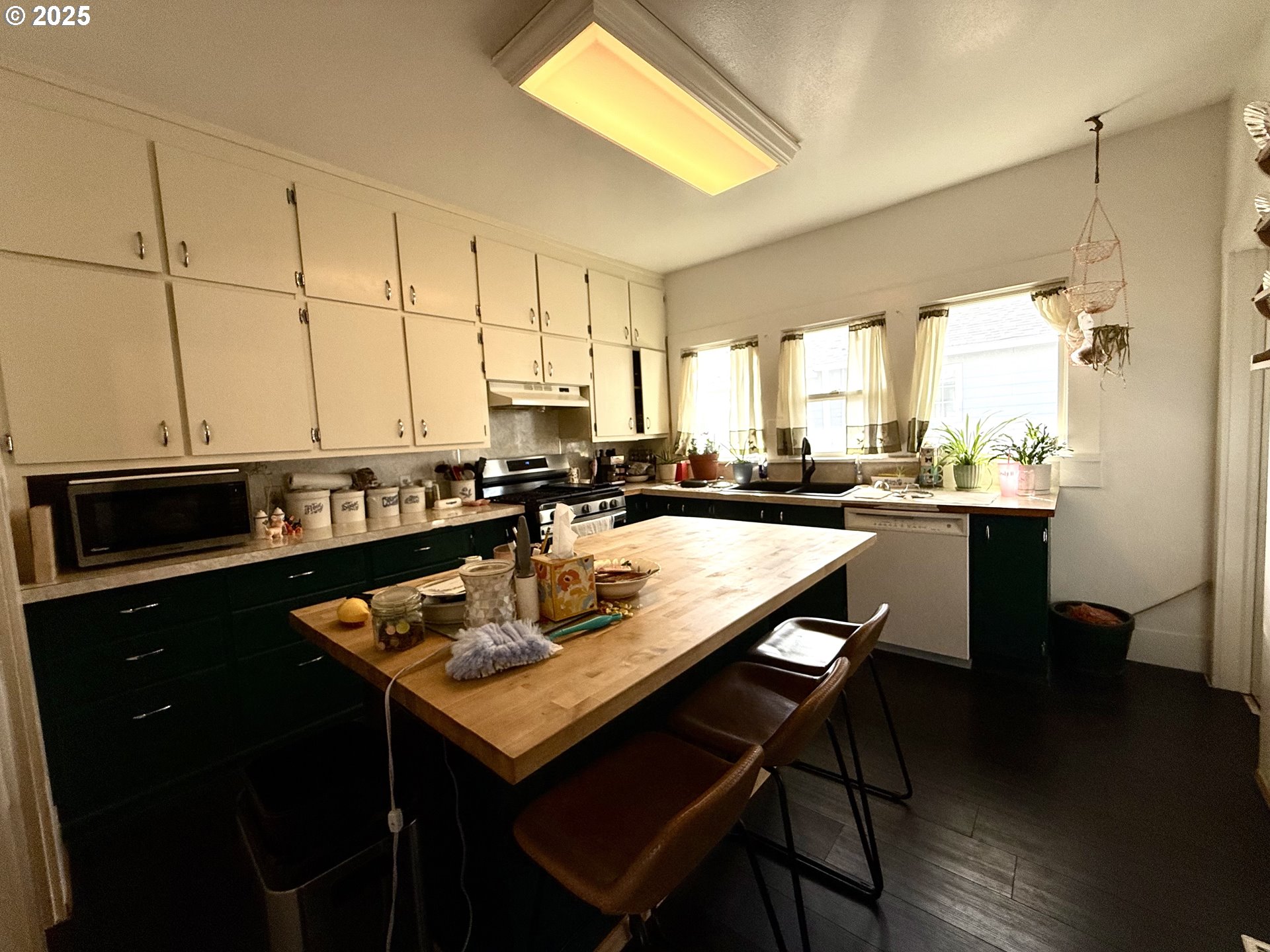 222 West Court Street Goldendale, WA 98620 - Photo 12 of 19 a kitchen with a sink a kitchen island and chairs in it