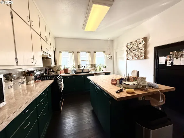 a kitchen with a sink stove and cabinets