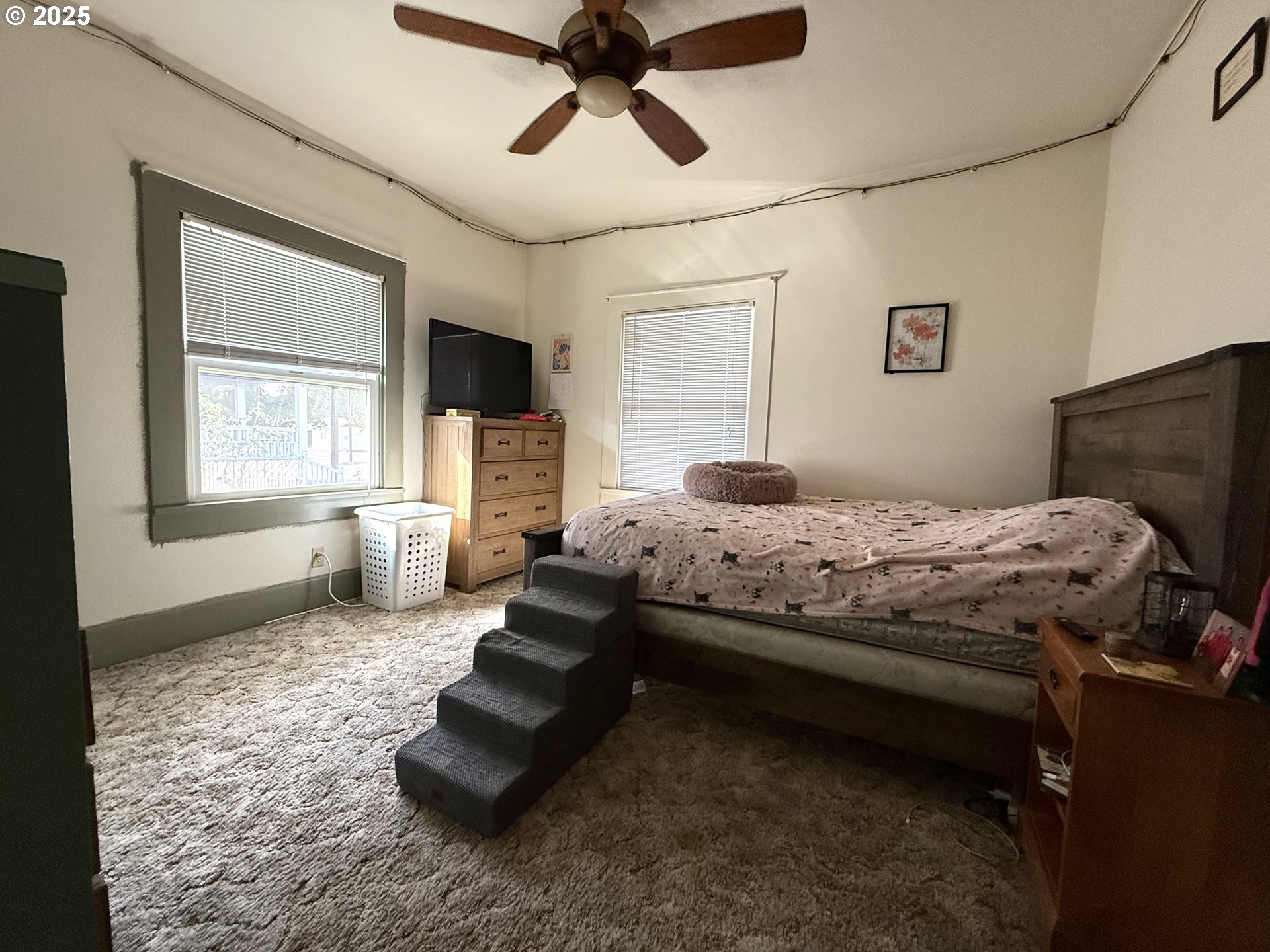 222 West Court Street Goldendale, WA 98620 - Photo 14 of 19 a bedroom with a bed and a chandelier