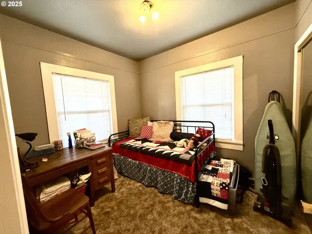 a bedroom with bed and a window