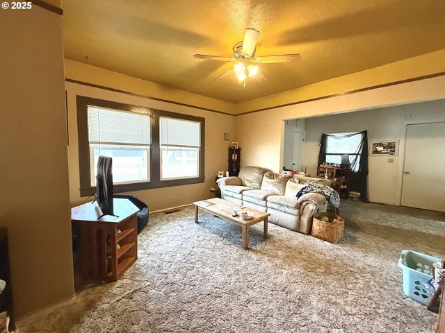 a living room with furniture and a large mirror