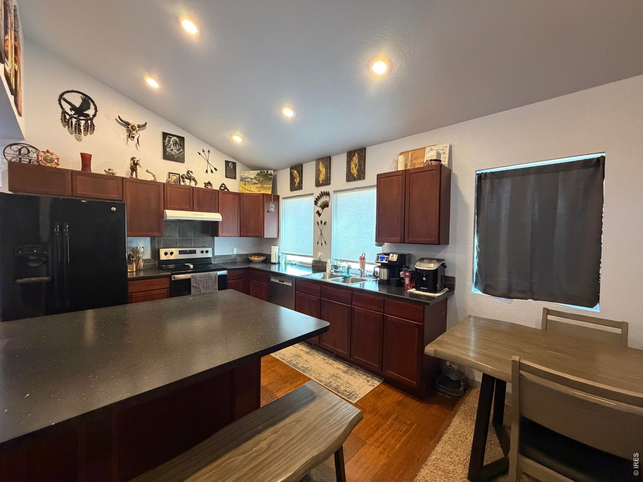 401 Church Street Kit Carson, CO 80825 - Photo 12 of 31 a kitchen with stainless steel appliances a stove refrigerator sink and wooden floor
