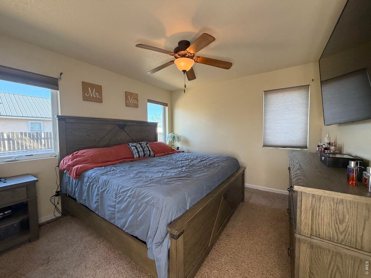 401 Church Street Kit Carson, CO 80825 - Photo 15 of 31 a bedroom with a bed and a chandelier