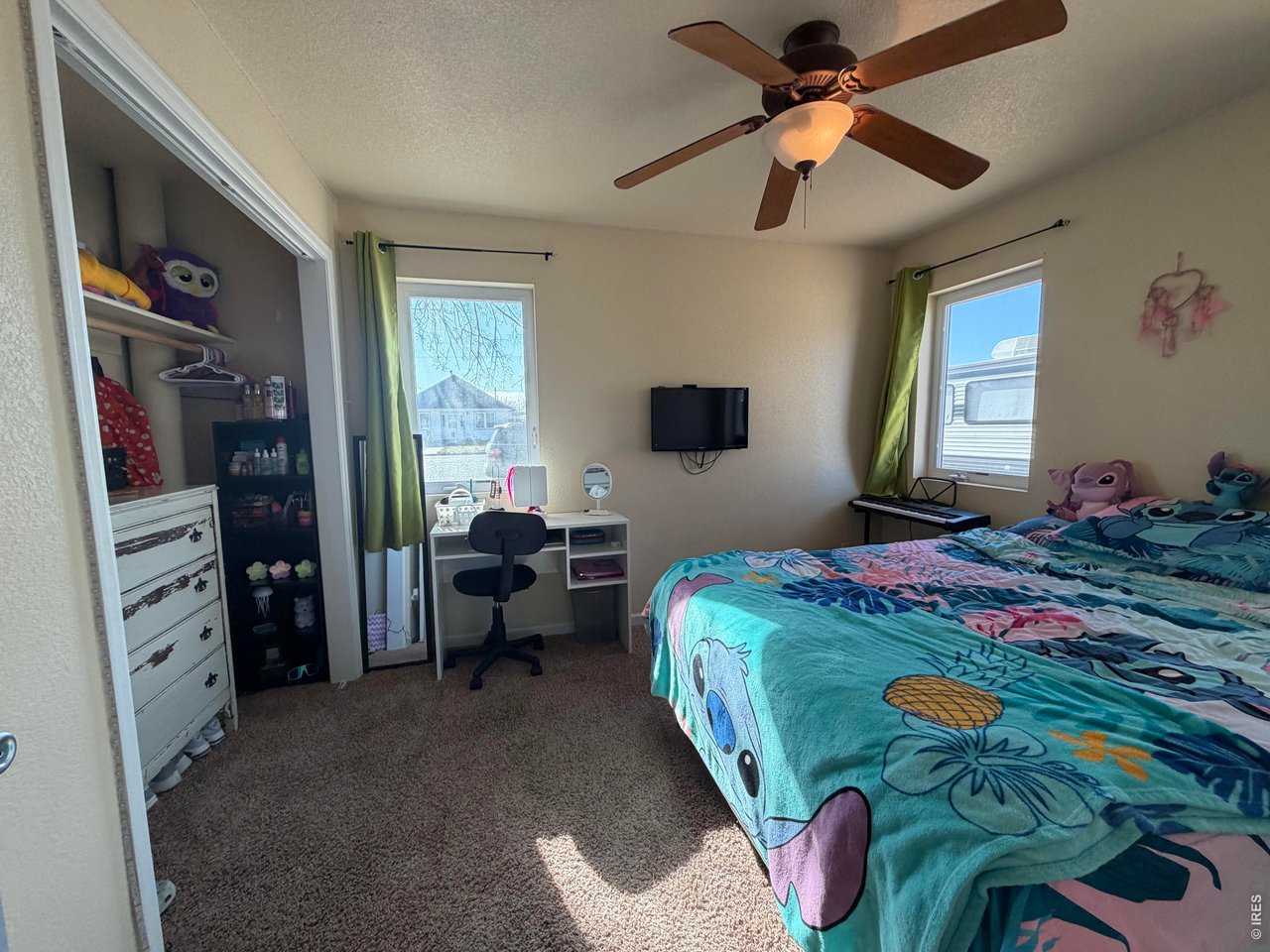 401 Church Street Kit Carson, CO 80825 - Photo 18 of 31 a bedroom with a bed and a chandelier