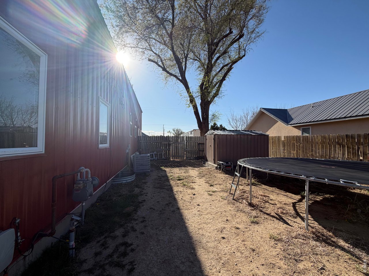 401 Church Street Kit Carson, CO 80825 - Photo 24 of 31 a backyard of a house with barbeque oven and trees