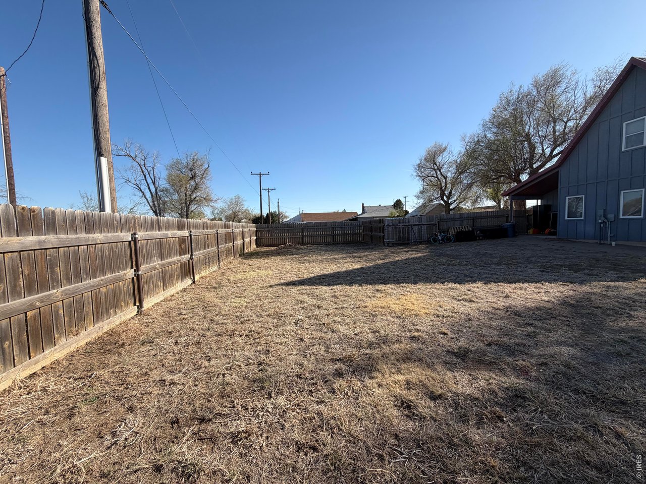 401 Church Street Kit Carson, CO 80825 - Photo 26 of 31 a view of a yard with wooden fence