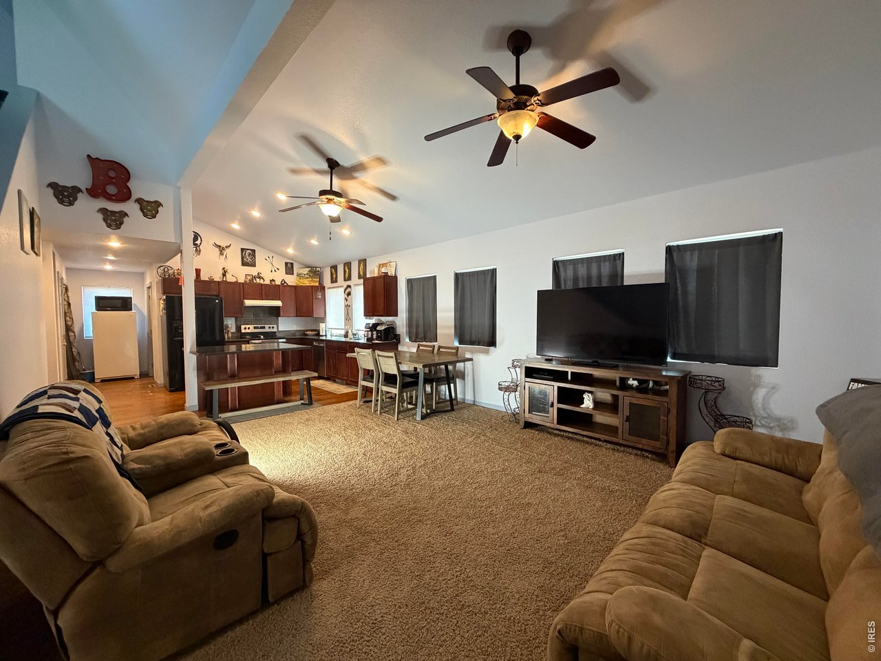 401 Church Street Kit Carson, CO 80825 - Photo 6 of 31 a living room with furniture and a flat screen tv with kitchen view