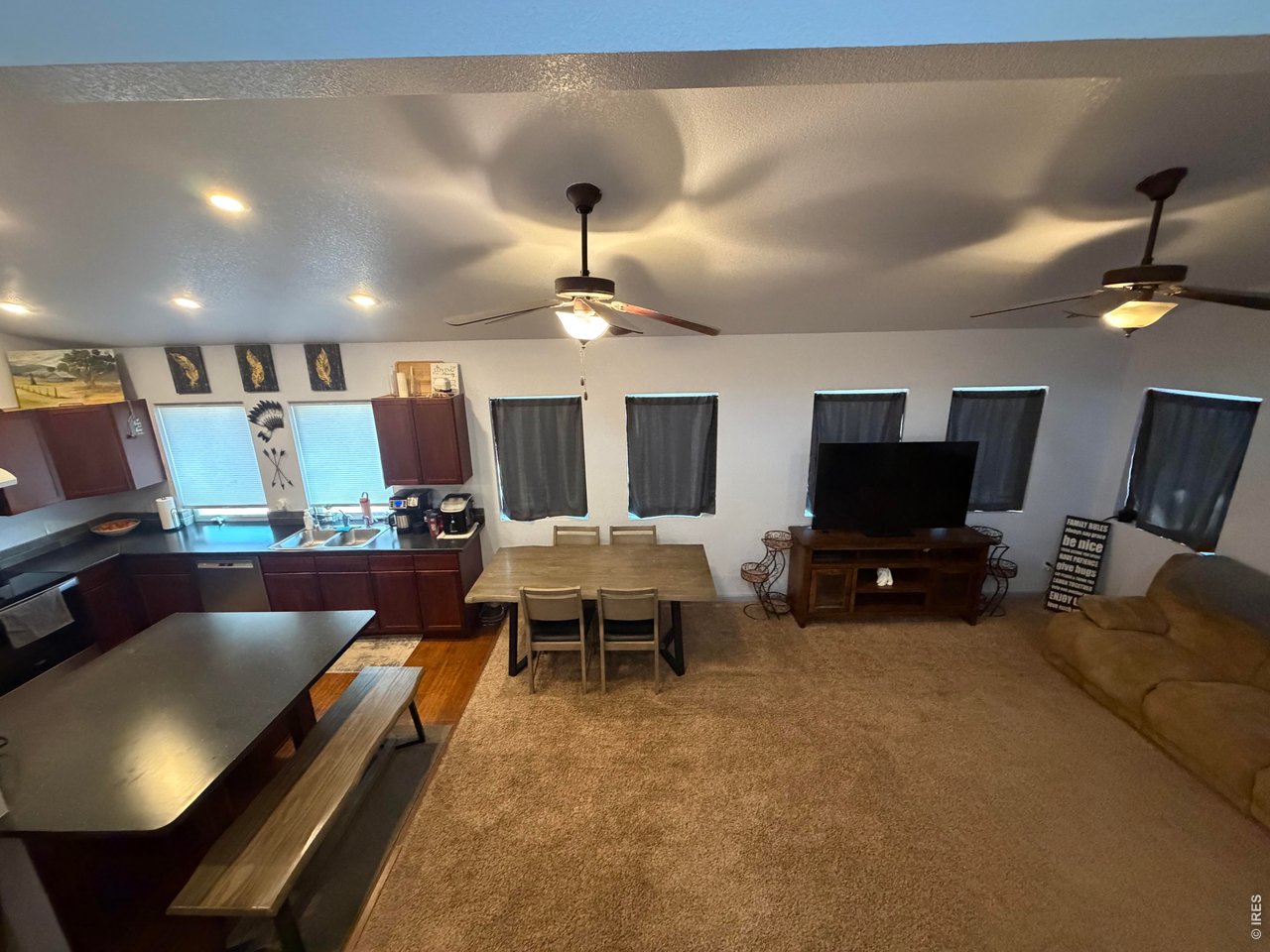 401 Church Street Kit Carson, CO 80825 - Photo 7 of 31 a living room with furniture a flat screen tv and kitchen view
