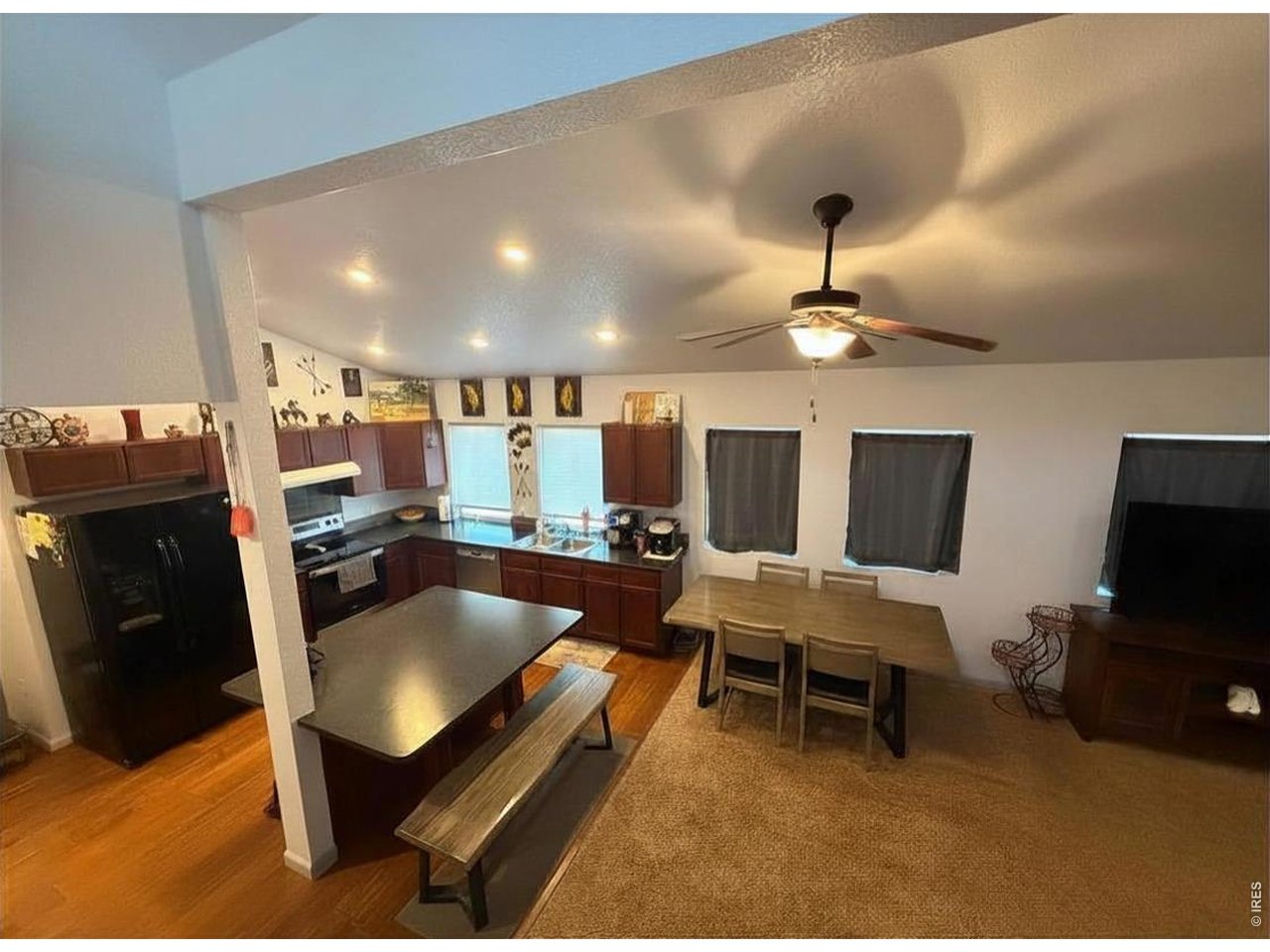 401 Church Street Kit Carson, CO 80825 - Photo 8 of 31 a living room with furniture a flat screen tv and kitchen view