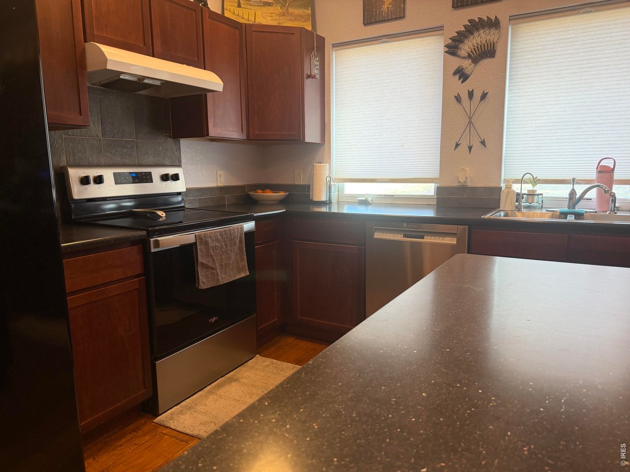 401 Church Street Kit Carson, CO 80825 - Photo 10 of 31 a kitchen with stainless steel appliances granite countertop a stove a sink and a microwave