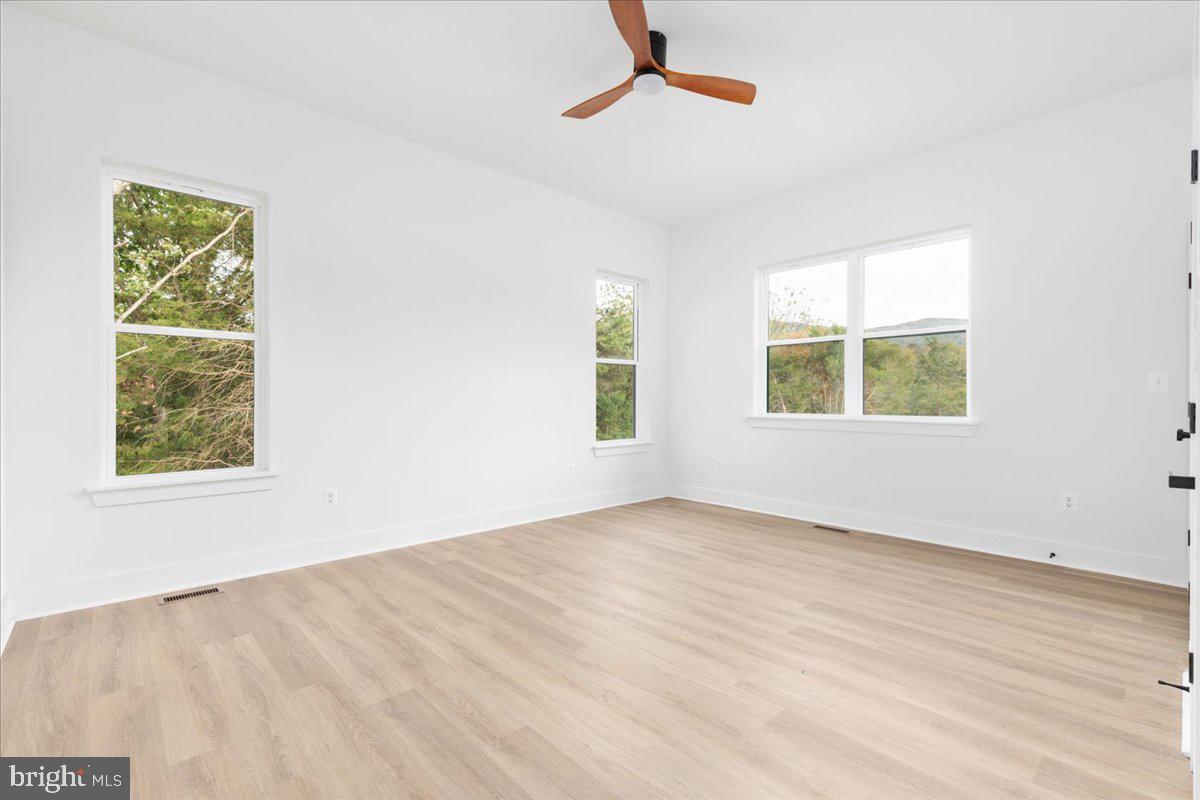 21 Mockingbird Lane Luray, VA 22835 - Photo 29 of 53 a view of an empty room with wooden floor and a window