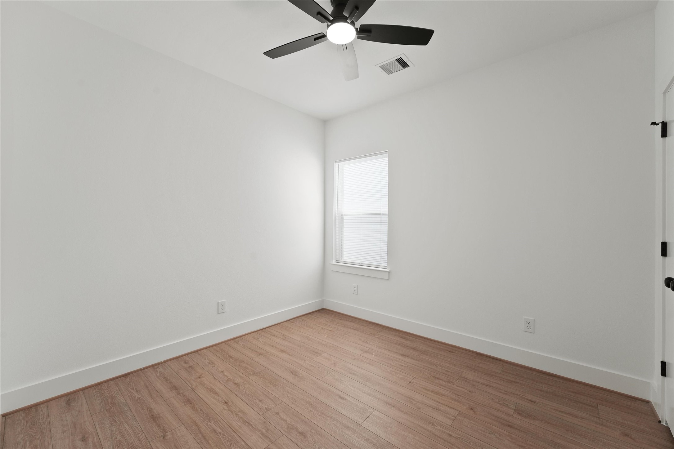 407 Calloway Street, Unit B Houston, TX 77029 - Photo 8 of 19 a view of an empty room with a window and wooden floor