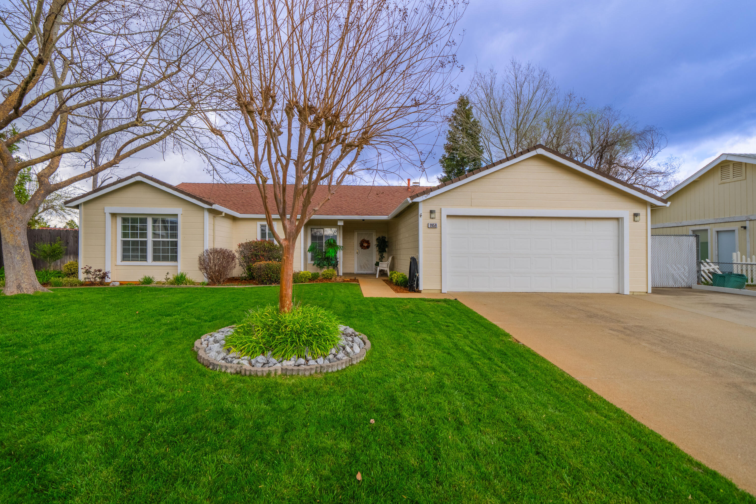 a front view of a house with a garden and yard